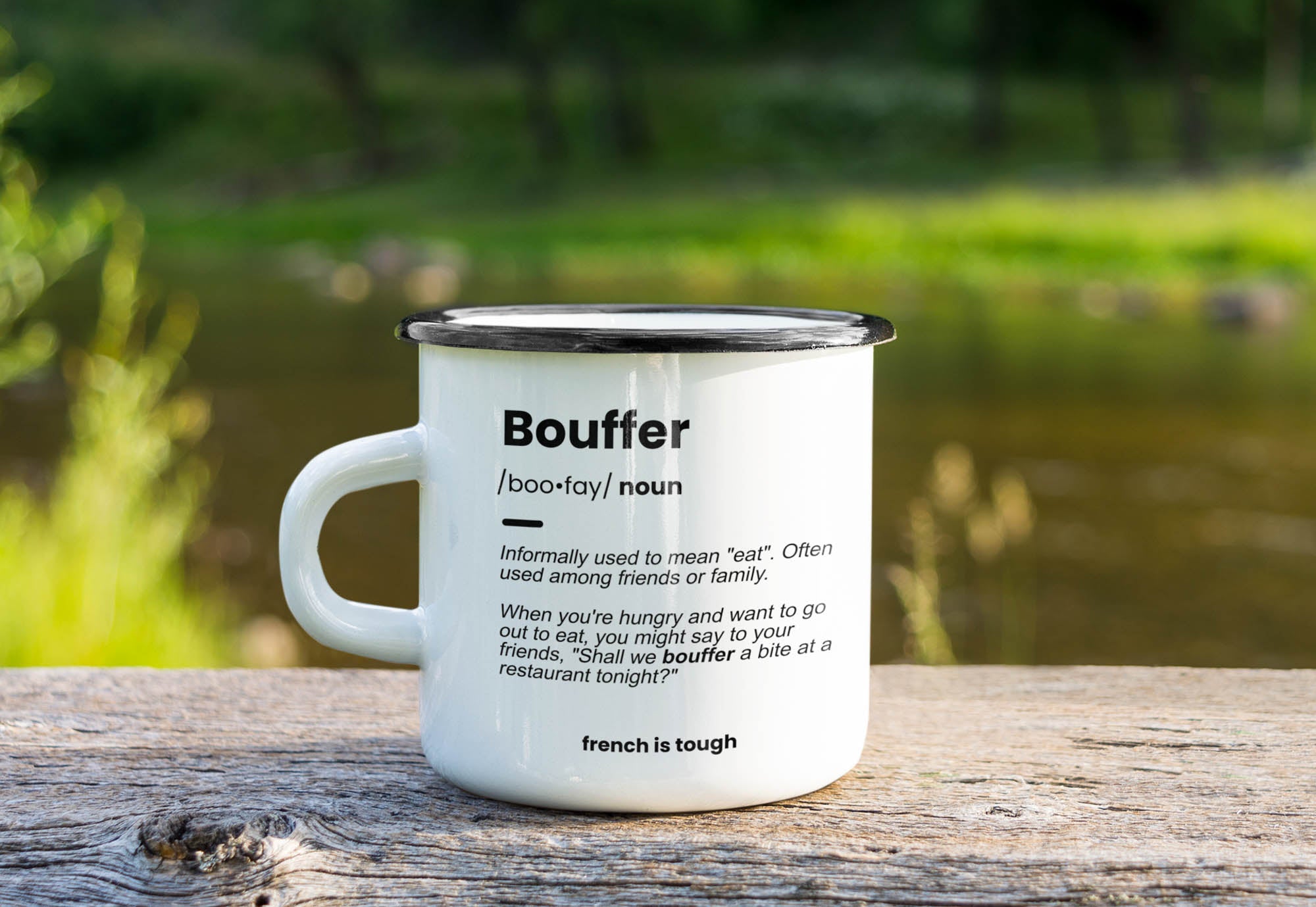 mockup-of-an-enamel-mug-placed-on-a-wooden-surface-by-a-pond-m9251-r-el2.jpg